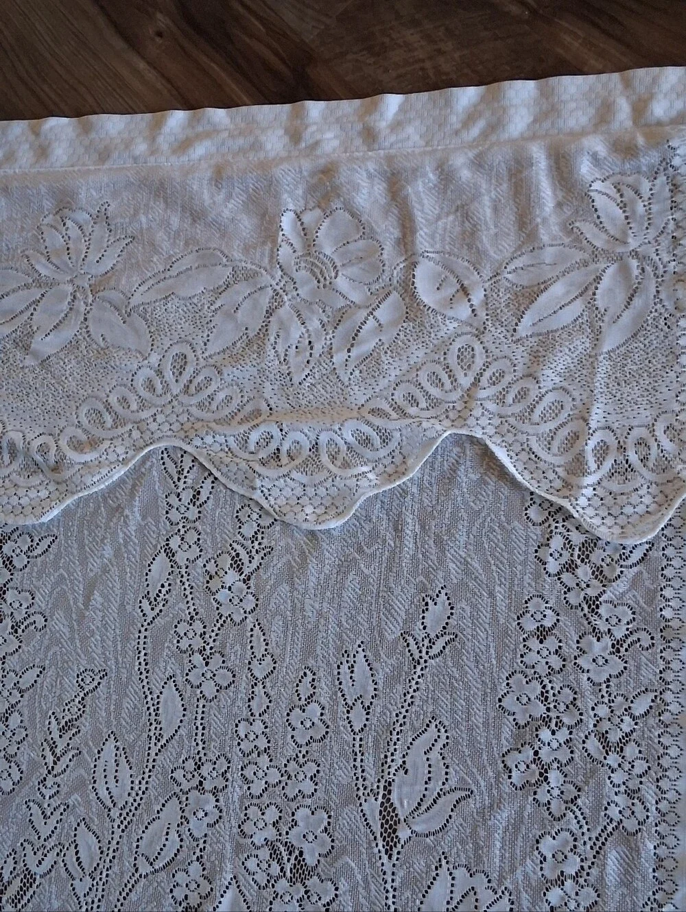 Vintage style floral lace curtain panel featuring an attached scalloped valance.